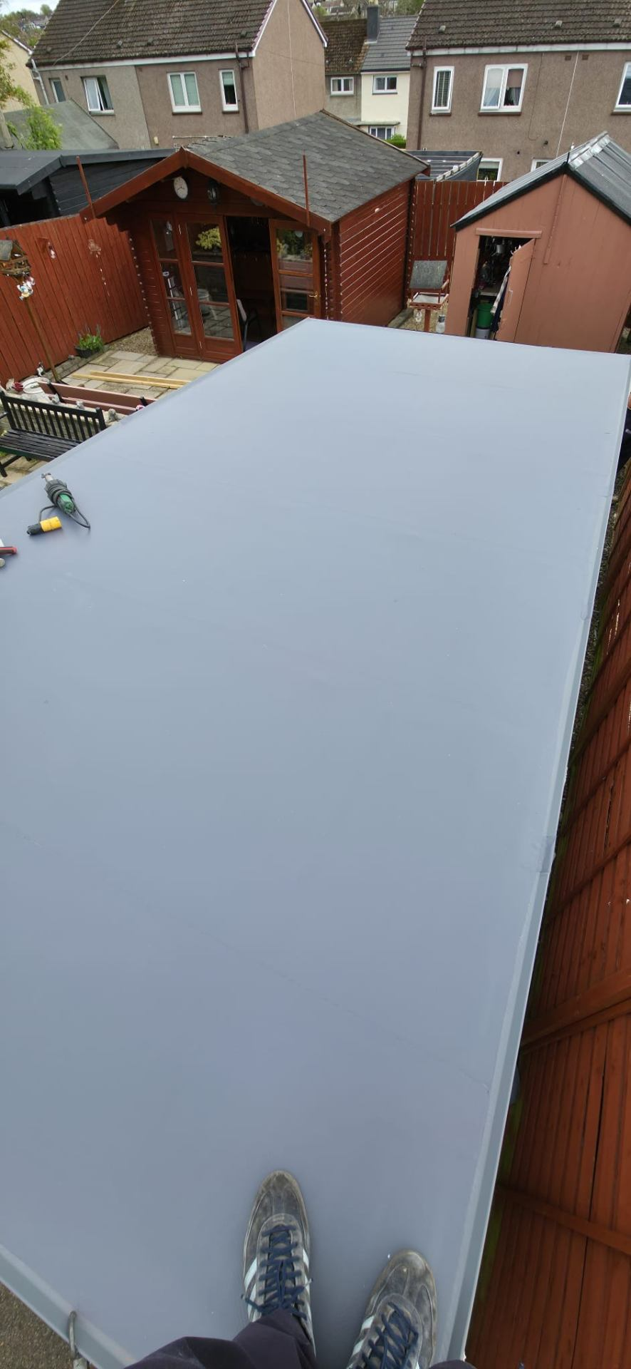 Newly installed grey PVC single ply flat roof, smooth and watertight — Rossi Roofing project